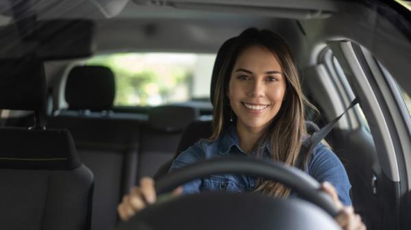 woman driving while inside car