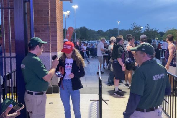 Reporter Deirdre Bardorf enters Citi Field wearing a MAGA hat and Trump 2024 t-shirt.