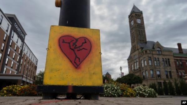 An image of a broken heart is fixed across the street from City Hall with the Heritage Center of Clark County, right, Sept. 17, 2024, in Springfield, Ohio.