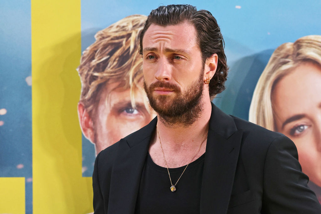 Aaron Taylor-Johnson in a black suit, best and gold necklace at the gala screening for The Fall Guy