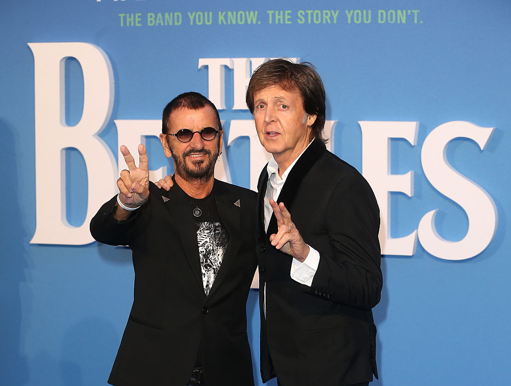 Ringo Starr and Sir Paul McCartney pose, making peace signs with their hands as they arrive for the World premiere of The Beatles: Eight Days A Week - The Touring Years in 2016