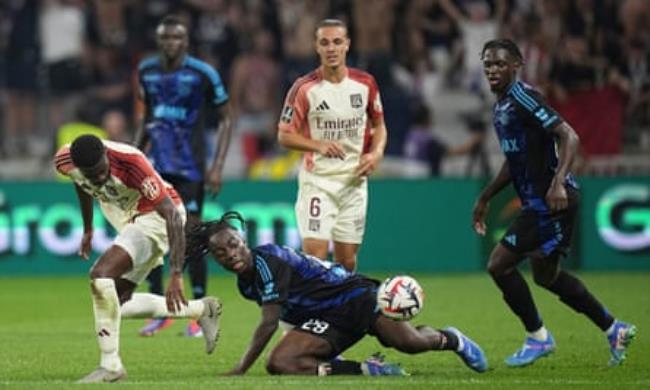 Lyon’s Ainsley Maitland-Niles (left) and Strasbourg’s Ismaël Doukouré tussle for the ball