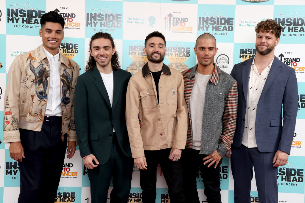 The Wanted members Siva Kaneswaran, Nathan Sykes, Tom Parker, Max George, and Jay McGuiness posing together at an event