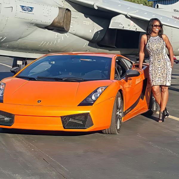 Tanya Smith alongside an orange sports car