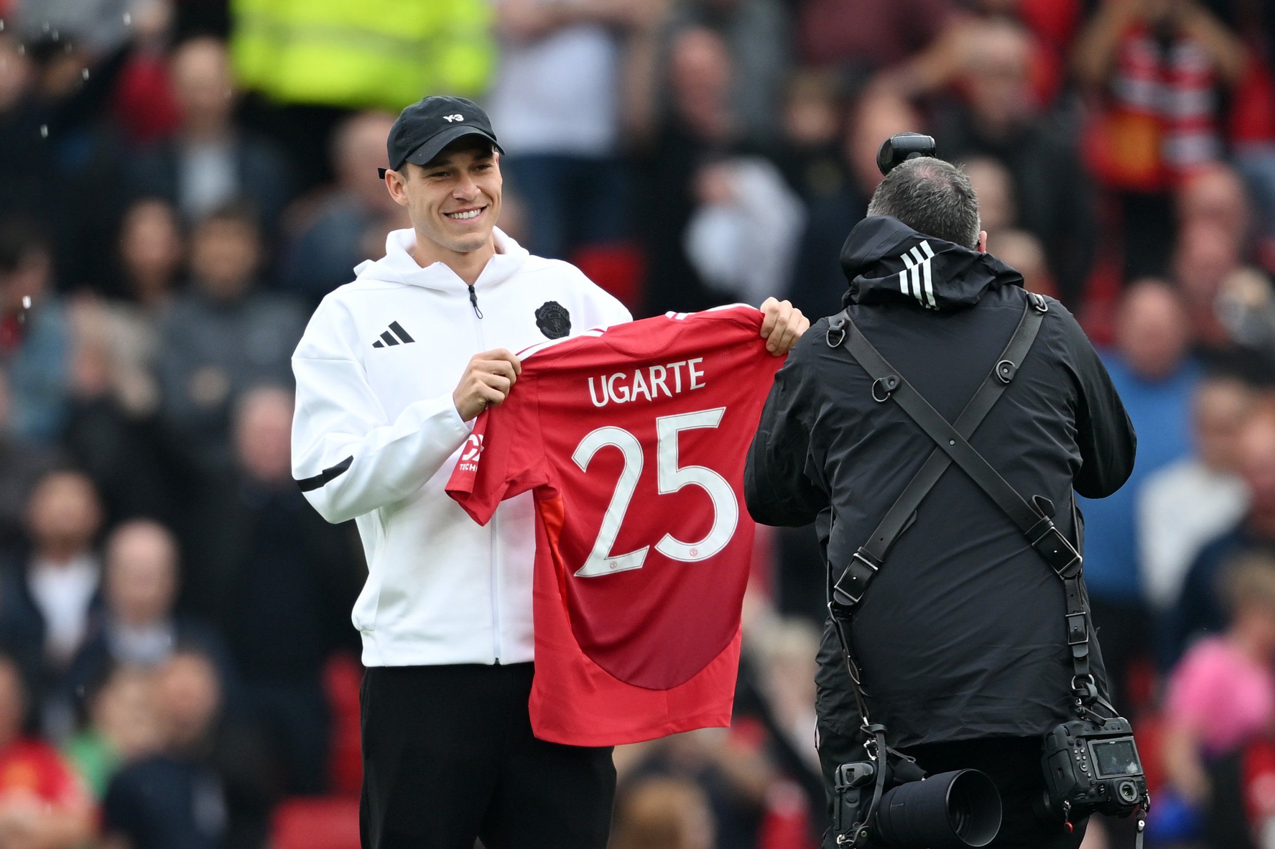 New signing, Manuel Ugarte of Manchester United, poses for a photo, as he holds up his shirt prior to the Premier League match between Manchester United FC and Liverpool FC at Old Trafford on September 01
