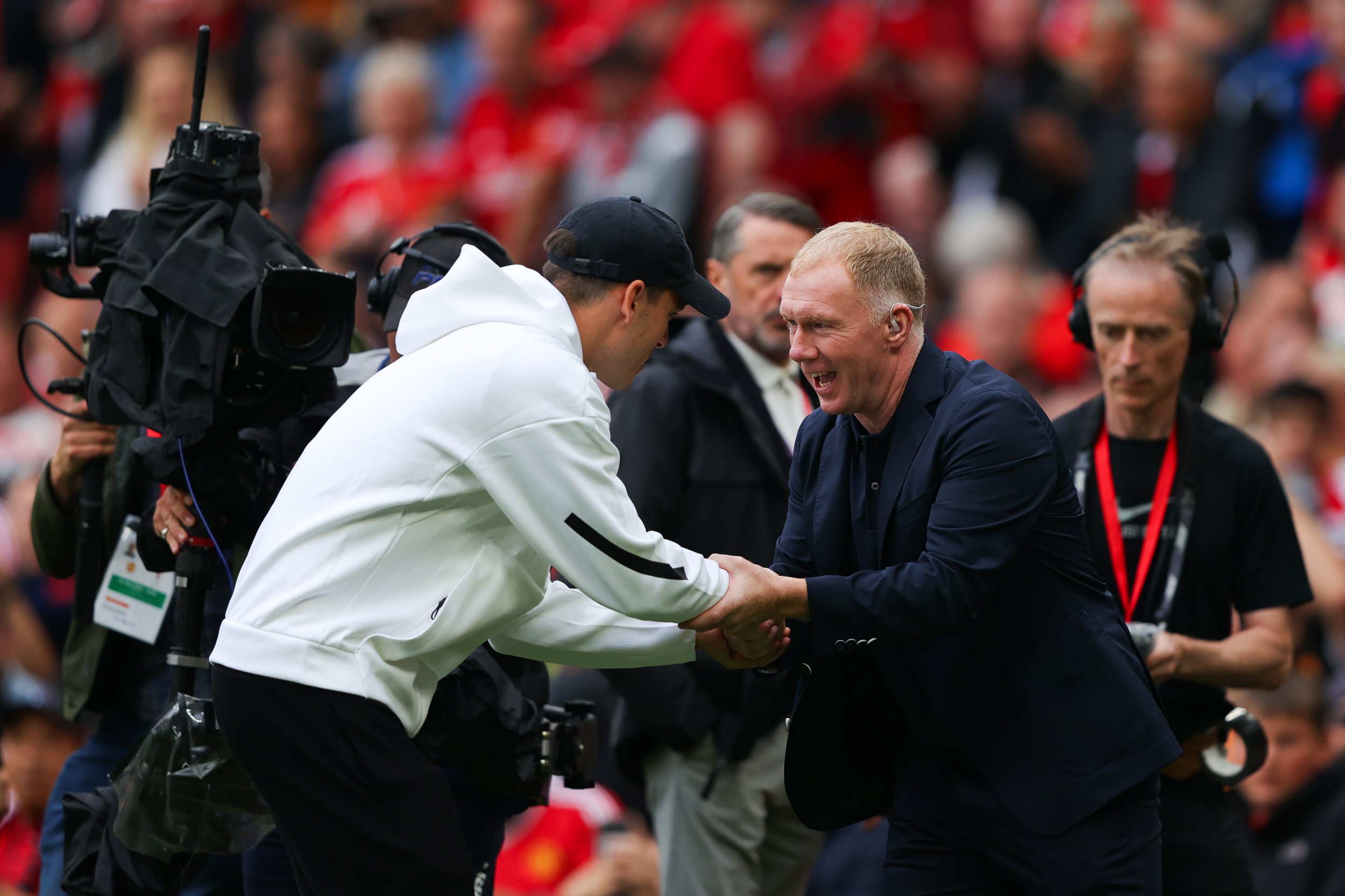 Manuel Ugarte of Manchester United is greeted by Paul Scholes after being unveiled as a new signing prior to the Premier League match between Manchester United FC and Liverpool FC at Old Trafford on September 01, 2024 in Manchester, England.