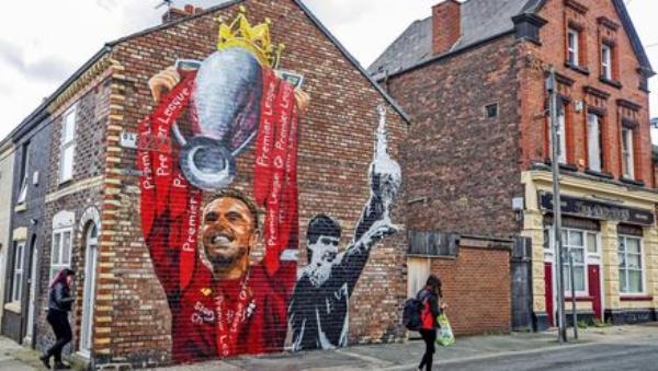 A new mural of Liverpool captain Jordan Henderson lifting the Premier League trophy and former captain Alan Hansen lifting the league trophy by artist Paul Curtis on the gable end of a house on Old Barn Road in Anfield, Liverpool. Photo credit: Peter Byrne/PA Wire A new mural of Liverpool captain Jordan Henderson lifting the Premier League trophy and former captain Alan Hansen lifting the league trophy by artist Paul Curtis on the gable end of a house on Old Barn Road in Anfield, Liverpool. Photo credit: Peter Byrne/PA Wire
