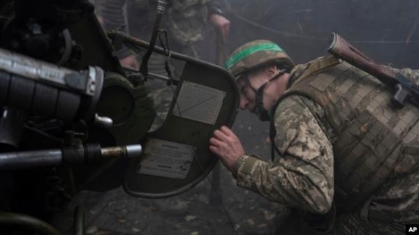 A Ukrainian serviceman of Khartia brigade checks a D-30 Howitzer after firing towards Russian positions in Kharkiv region, Ukraine, Oct. 16, 2024.