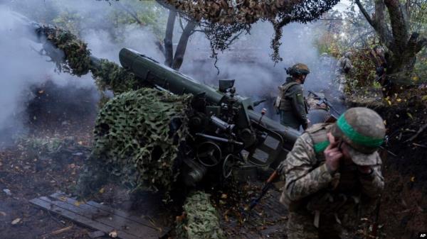 Ukrainian servicemen of Khartia brigade fire a D-30 Howitzer toward Russian positions in Kharkiv region, Ukraine, Oct. 16, 2024.