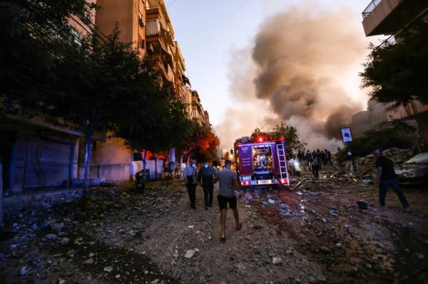 First responders rush to the site of an Israeli airstrike in the Haret Hreik neighborhood in Beirut on Sept. 27, 2024.