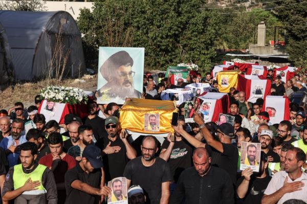 Mourners attend a mass funeral on Sept. 27, 2024, for 16 people killed in Israeli strikes on the Mount Lebanon village of Maaysra earlier in the week.