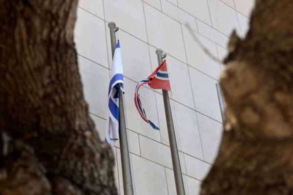 The Israeli (L) and Norwegian flags flutter outside the building housing the offices of the Norwegian Embassy in the central Israeli city of Tel Aviv