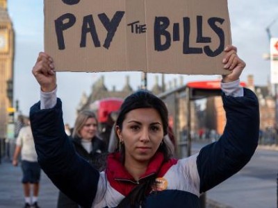 A protester holds a placard reading
