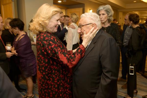 Actress Liv Ullman holds the face of Henry Kissinger at a 2017 awards dinner