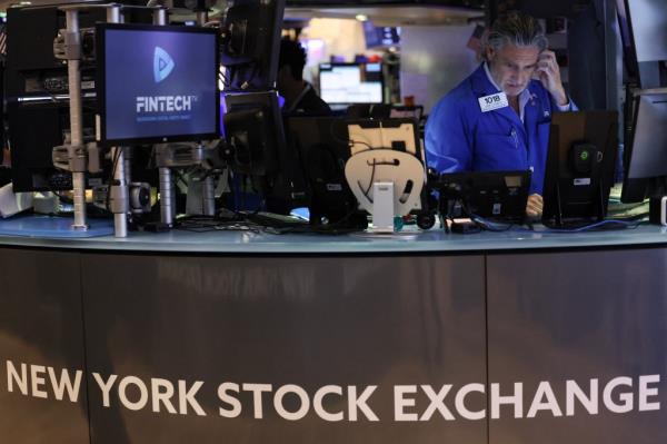 A trader works on the floor of the New York Stock Exchange.