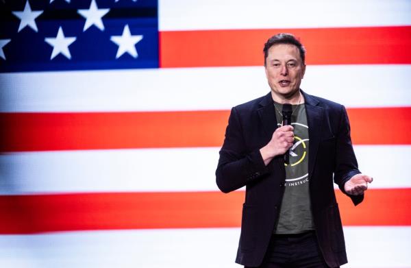 Musk handed an over-sized million dollar check to John Dreher, who Musk said was randomly selected to receive the jaw-dropping sum.