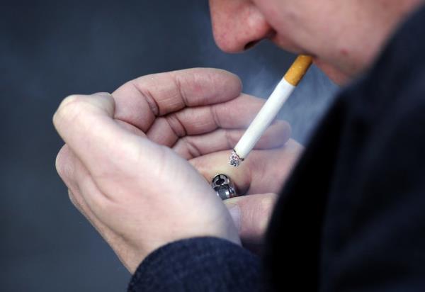 Man lighting cigarette.