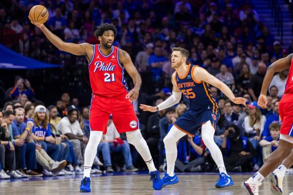 Joel Embiid #21 of the Philadelphia 76ers looks for an opening as Isaiah Hartenstein #55 of the New York Knicks defends