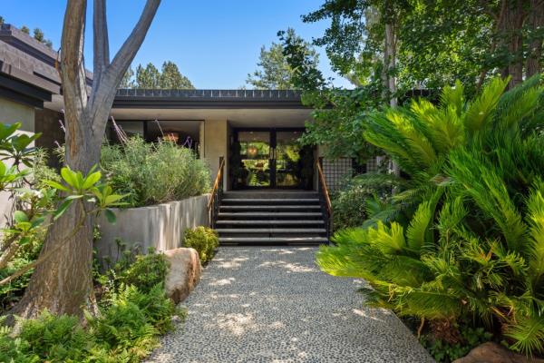 Actor Jeremy Renner's luxury Zen house in Los Angeles with a walkway leading to the building, recently put on the market for $12.9 million