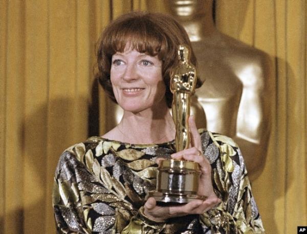 FILE - Actress Maggie Smith holds her Oscar for best supporting actress in the film 