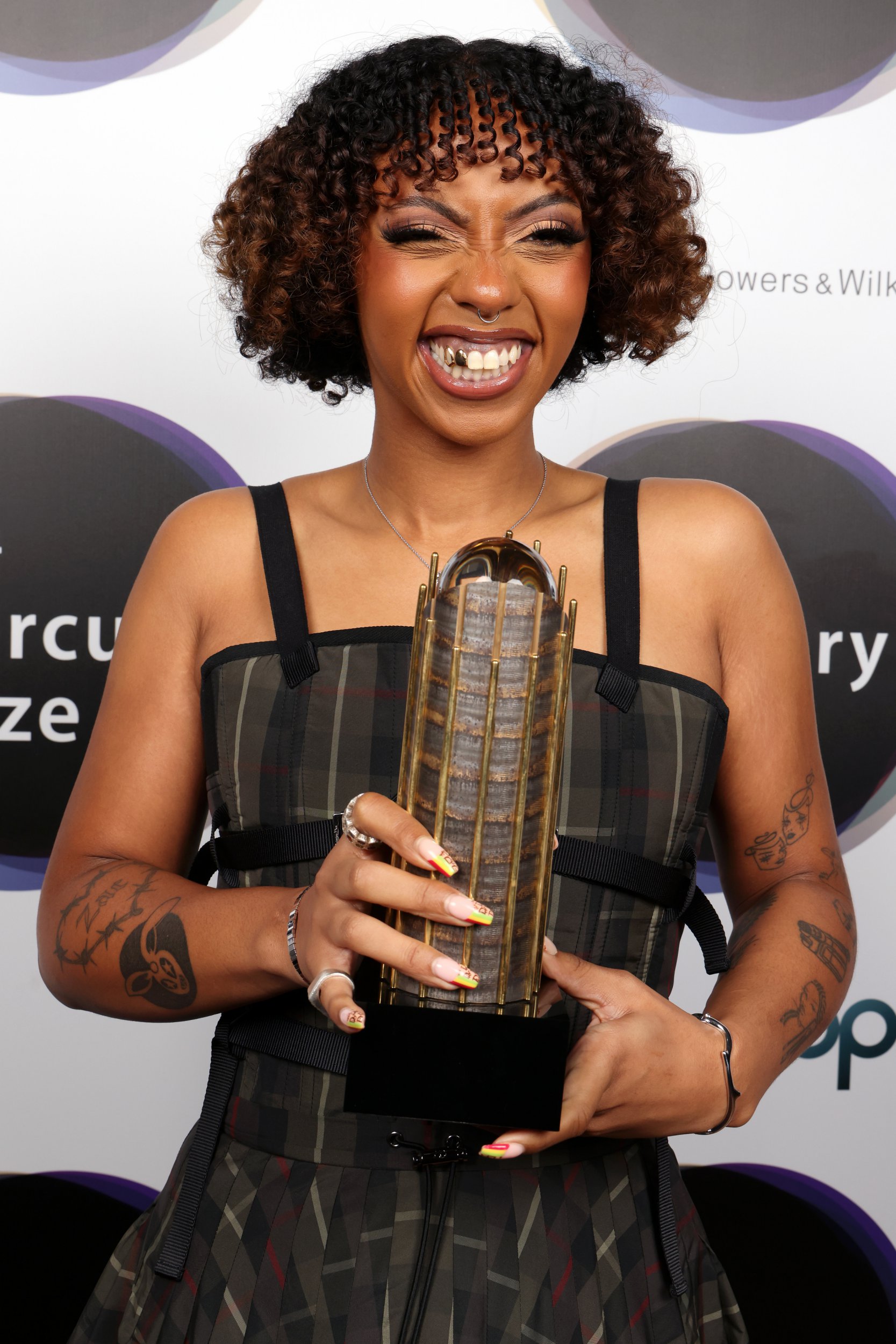 Nia Archives beams as she holds Mercury Award Prize trophy