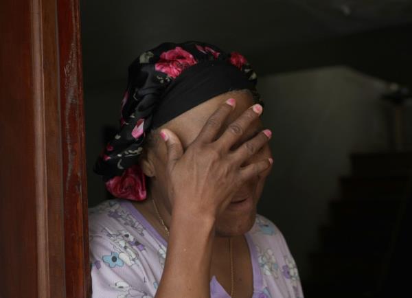 The aunt covers her face to shield her niece's identity.