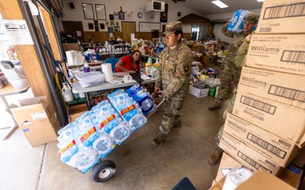 Soldiers with the 101st Airborne Division Air Assault, 2nd Brigade Combat Team, from Fort Campbell, Ky., help volunteers distribute water, food, toiletries, and other aid to residents in Maggie Valley on Tuesday, Oct. 8, 2024.