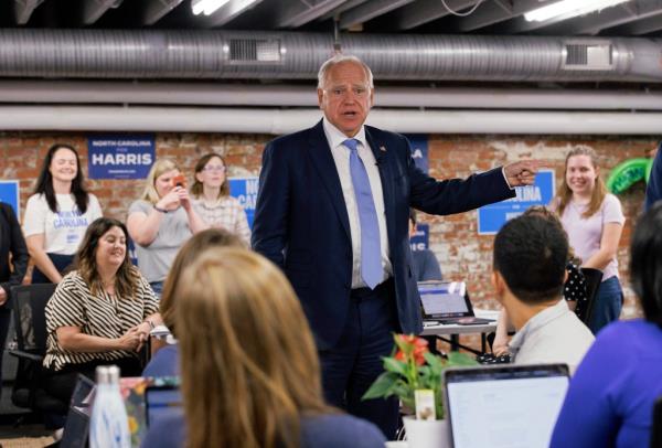 Democratic vice presidential candidate, Minnesota Gov. Tim Walz engaging in a conversation with volunteers at a campaign office in Raleigh, N.C. in 2024