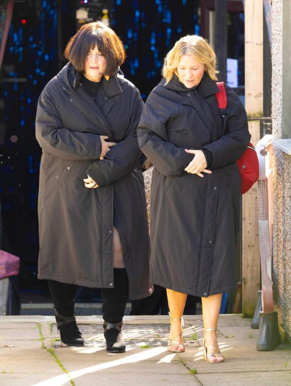Ruth Jones as Nessa and Joanna Page as Stacey wrapped up in black coats on the Gavin and Stacey set
