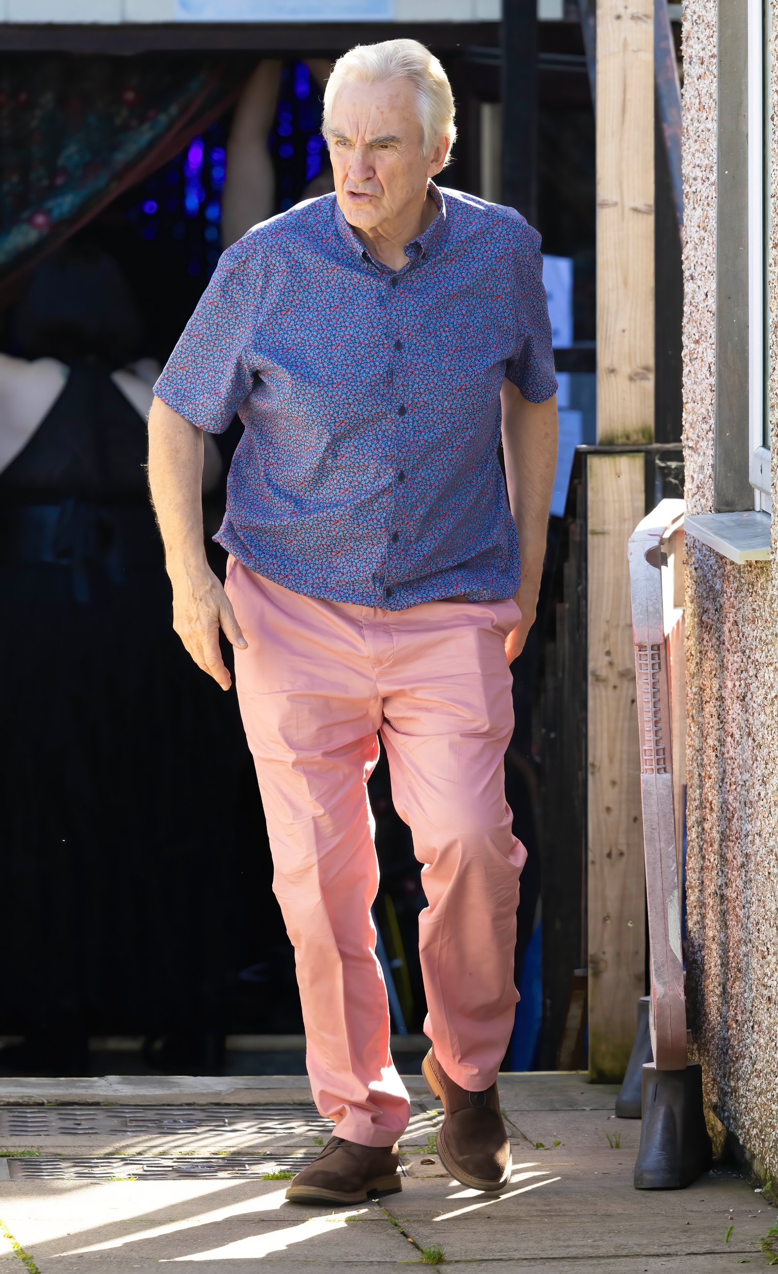 Larry Lamb as Mick wearing a blue floral shirt and pink trousers on the Gavin and Stacey set