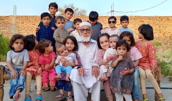 Fazal Haq with his grandchildren in his village in Karak district, Khyber Pakhtunkhwa, Pakistan. (AN Photo)