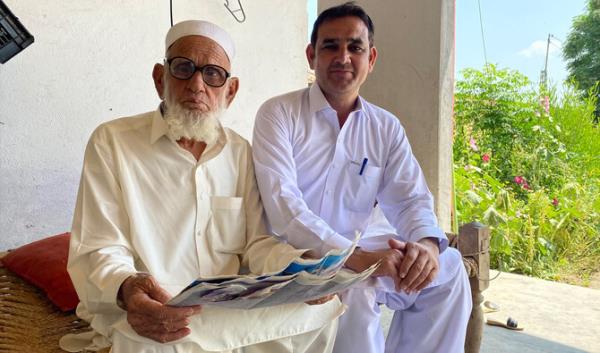 Fazal Haq with his son in his village in Karak district, Khyber Pakhtunkhwa, during an interview with Arab News. (AN Photo)
