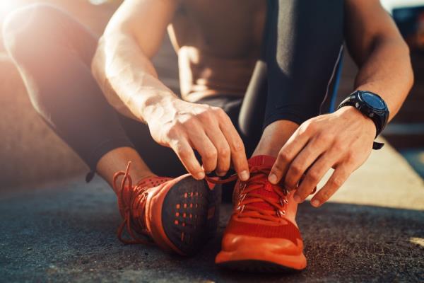 man tying shoes