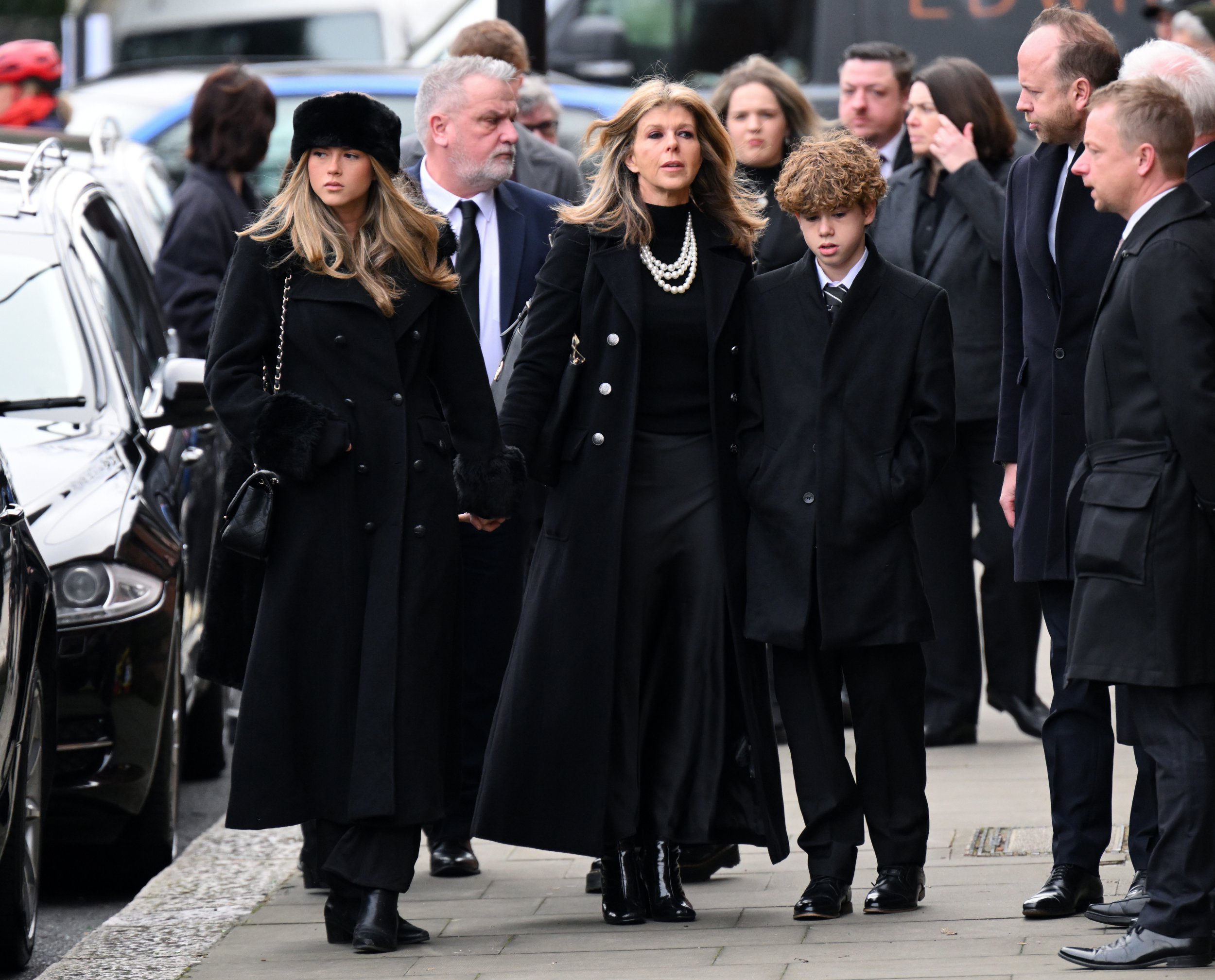 Darcey Draper, Kate Garraway and Billy Draper wear black and look glum as they attend the funeral of Derek Draper 