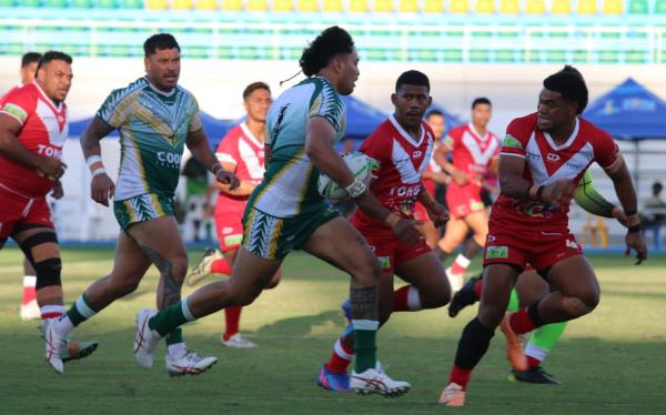 The Cook Islands' Adya Angana has a crack at Tonga's Ulukaulupe Akolo during the 2023 Pacific Games in Solomon Islands. 21 November 2023