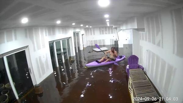 Matt Heller, paddled around his flooded Tampa Bay home inside a kayak he had prepared incase he need a quick escape during Hurricane Helene.