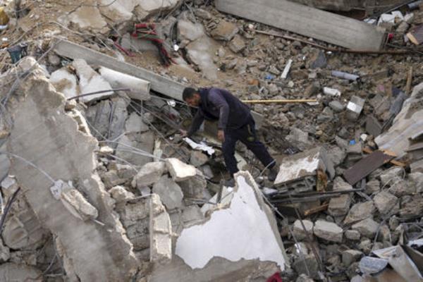A Palestinian looks at the destruction after an Israeli strike at a residential building in Deir al Balah, Gaza Strip on Sunday. (Picture: AP Photo/Adel Hana) A Palestinian looks at the destruction after an Israeli strike at a residential building in Deir al Balah, Gaza Strip on Sunday. (Picture: AP Photo/Adel Hana)