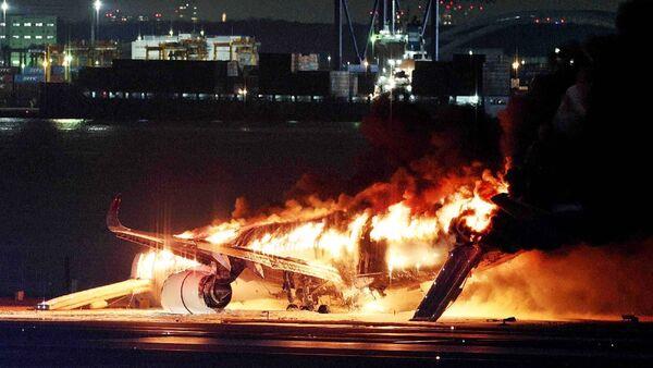 Japan coast guard members reported dead after passenger plane crash on runway