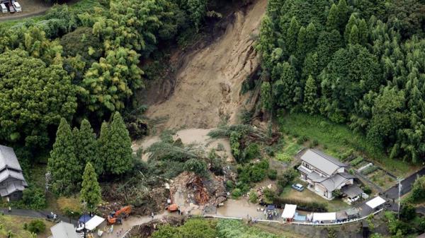 This aerial image shows the landslide in Gamagori, Aichi prefecture, Japan, Wednesday, Aug. 28, 2024. Ahead of the typhoon's arrival, heavy rain caused a landslide that buried a house in the central city of Gamagori. (Kyodo News via AP)