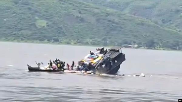 FILE - In this video frame grab, a boat sinks in the Congo river outside Kinshasa, Democratic Republic of Congo, Feb. 12, 2024.