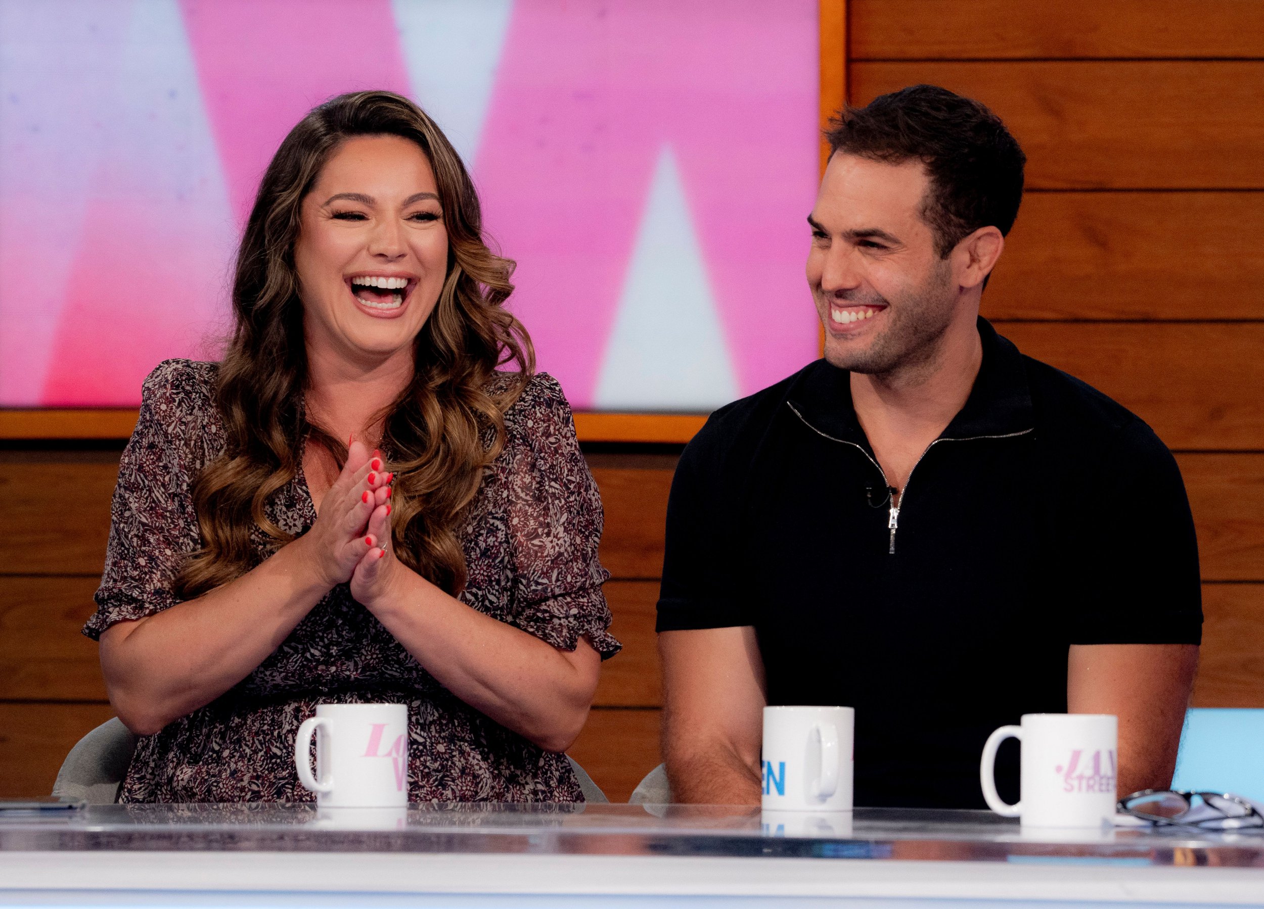 Kelly Brook and Jeremy Parisi laugh together on Loose Women