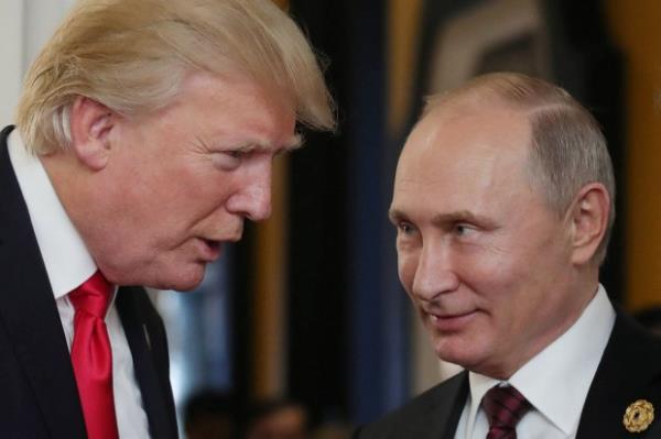 President Donald Trump (L) chats with Russia's President Vladimir Putin as they attend the APEC Economic Leaders' Meeting, part of the Asia-Pacific Economic Cooperation (APEC) leaders' summit in the central Vietnamese city of Danang on November 11, 2017. (Photo by MIKHAIL KLIMENTYEV/SPUTNIK/AFP via Getty Images)