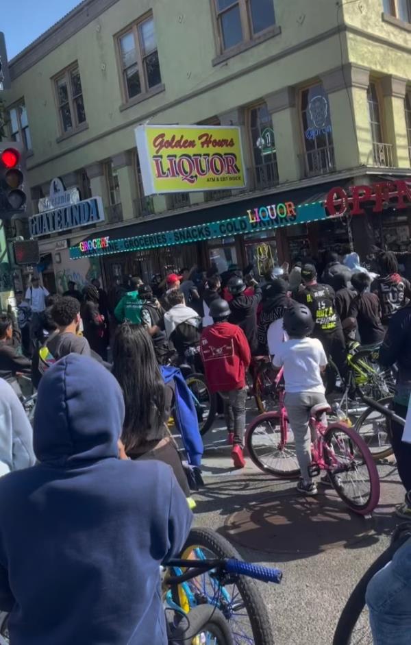 The unidentified employee was standing outside Golden Hours Liquor on International Boulevard in Oakland on Saturday where he confronted the bicyclists who had surrounded the area outside of the store.