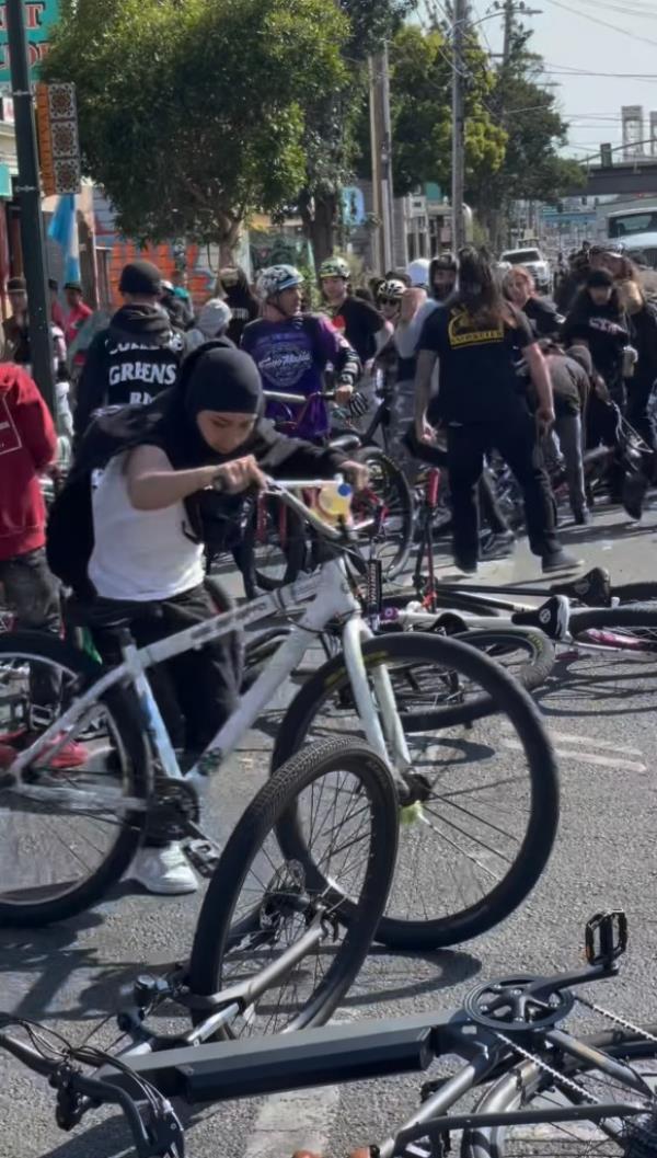 A separate video captured the worker chasing down one of the bikers in a gray hoodie and face mask before swiping at him, forcing the biker to fall down.