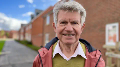 Martin Giles/BBC Bengt Larson standing near a new development in the Mount Road/Saltsmarsh Road area of Bury St Edmunds