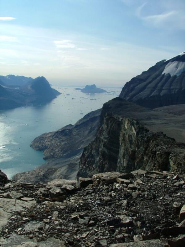 A view of a rocky mountain and water