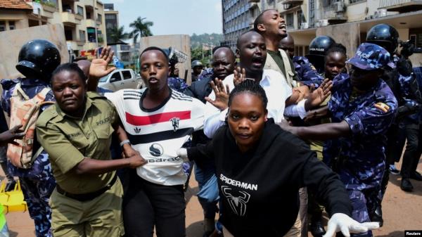 Ugandan police officers detain protestors during a rally against what the protesters say are rampant corruption and human rights abuses by the country's rulers in Kampala, Uganda, July 23, 2024. 