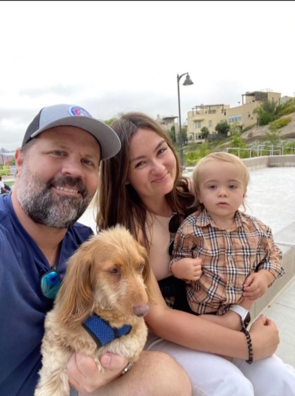 James Carter, Anastacia Duboshina and Nico Carter are pictured with their dog.