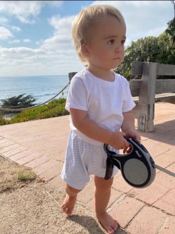 Nico is pictured near the water holding his dog's leash.