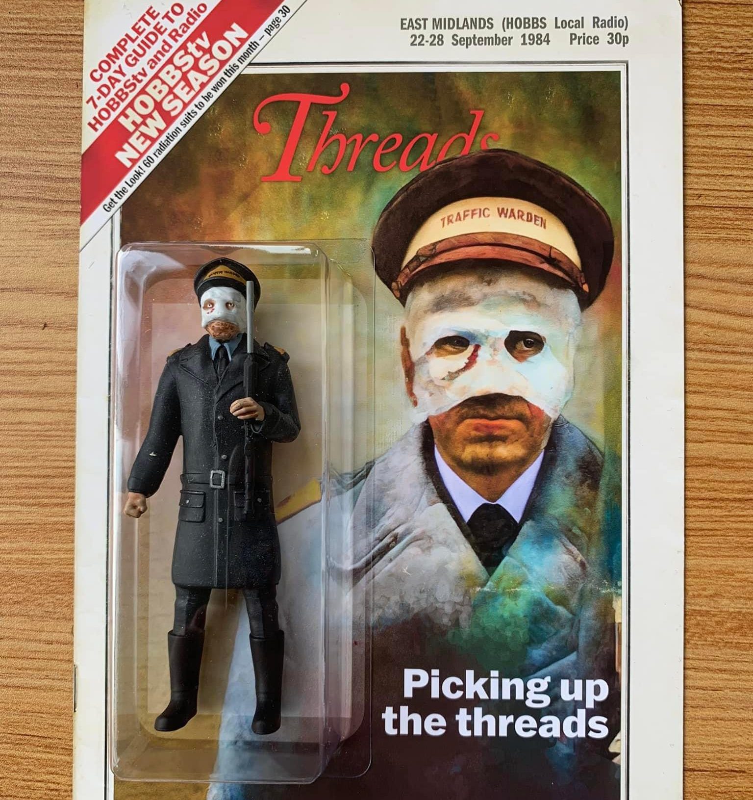A photo of a Threads action figure - of the traffic warden with a bandaged face